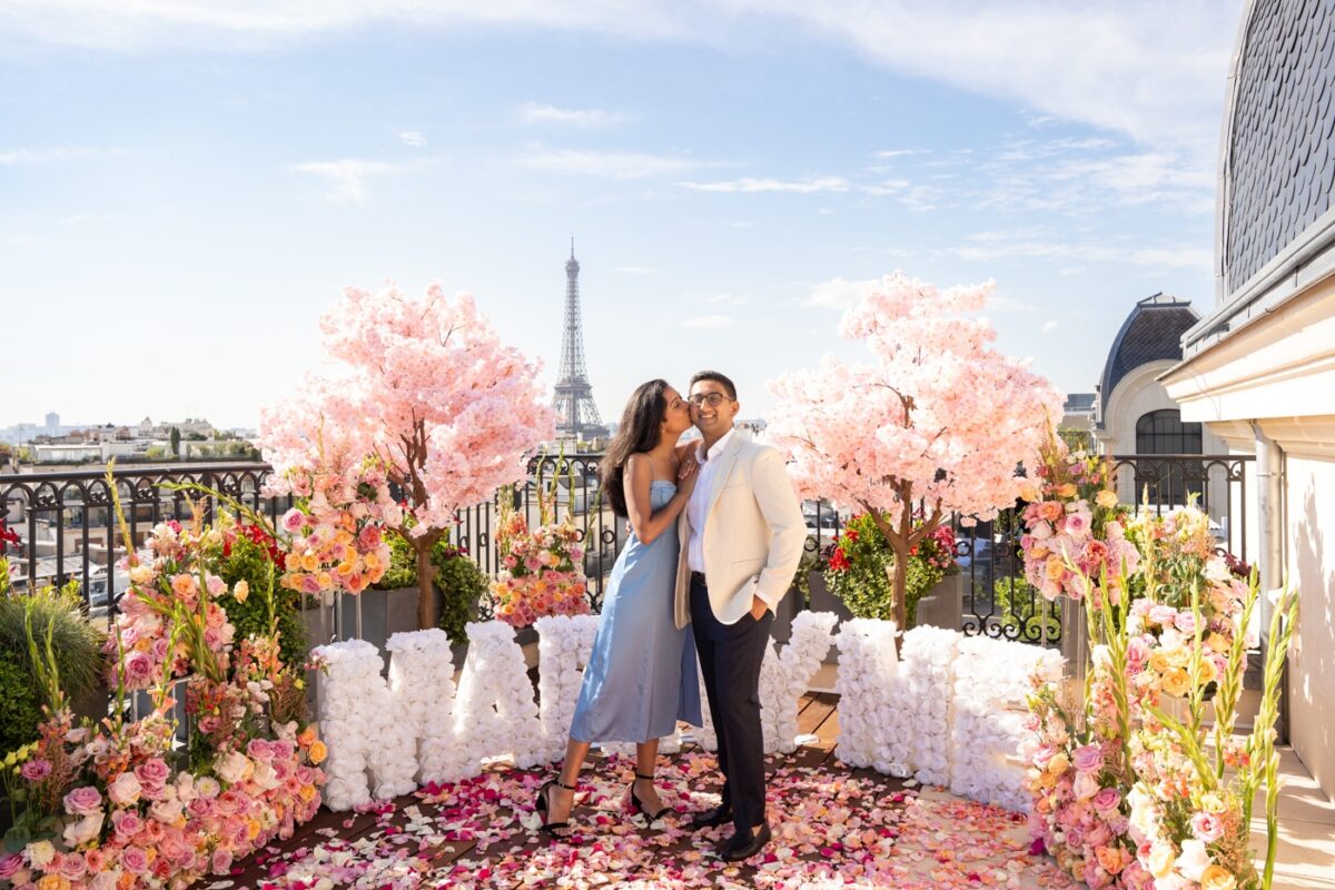 white Marry Me Letters surrounded by Cherry Blossoms trees and colorful rose bushes - Peninsula hotel Paris