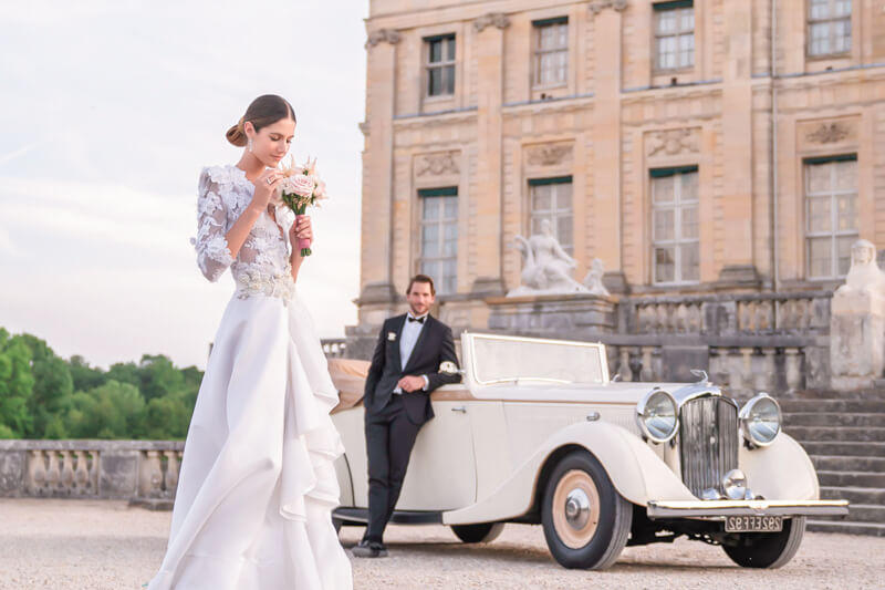 Elegant elopement at Château Vaux-le-Vicomte with bride in Frédéric Alzra Couture and groom by vintage car