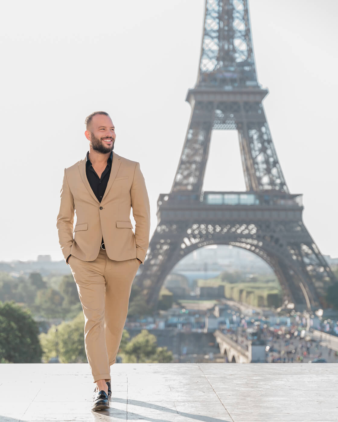 Vincent Lillo, founder of Events in Paris, wearing designer suit at Trocadero plaza with Eiffel Tower backdrop, showcasing the elegance of luxury Paris event planning